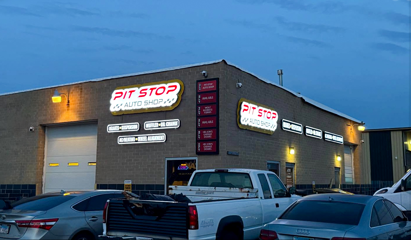 Pit Stop Auto Shop building with illuminated custom exterior signs