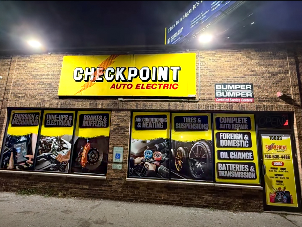 Checkpoint Auto Electric storefront with yellow and black printed window graphics