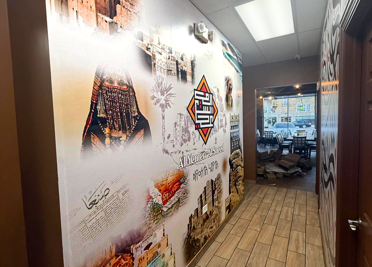 Al Yemen Al Saeed restaurant interior with a large custom cultural wall mural