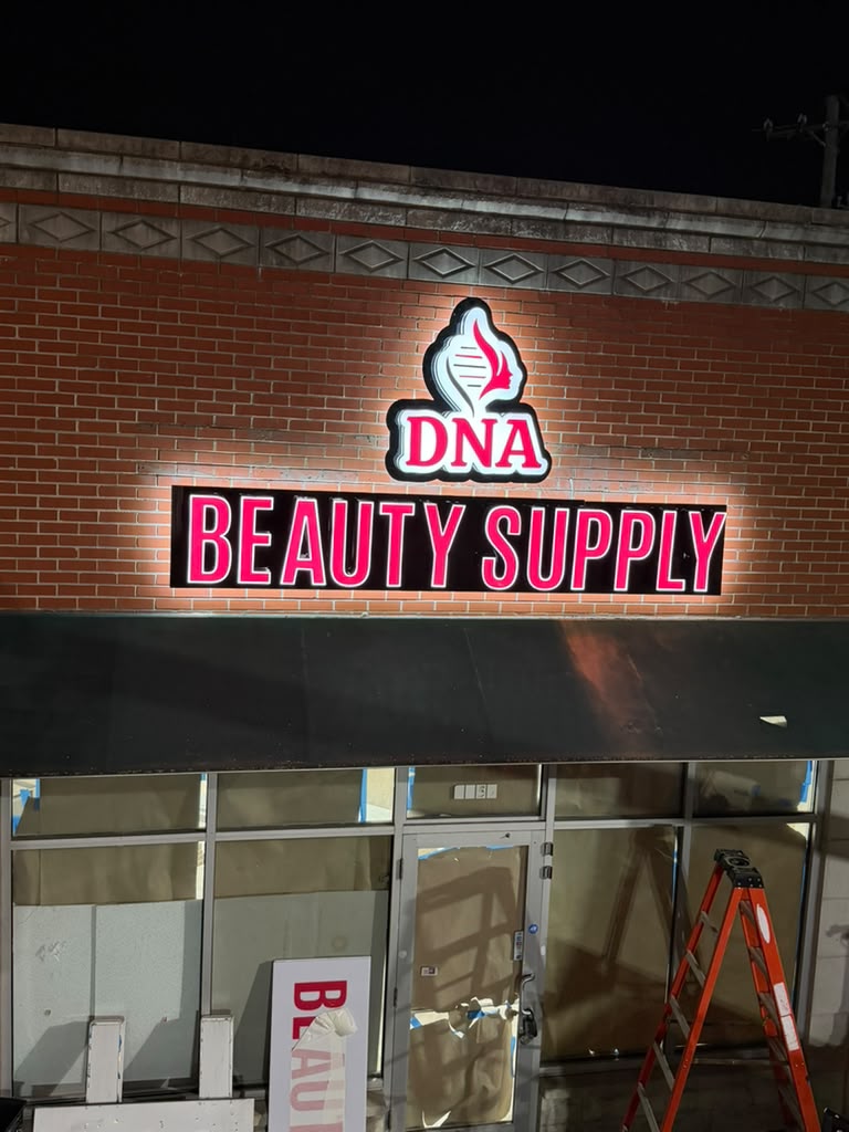 DNA Beauty Supply illuminated storefront sign glowing red at night