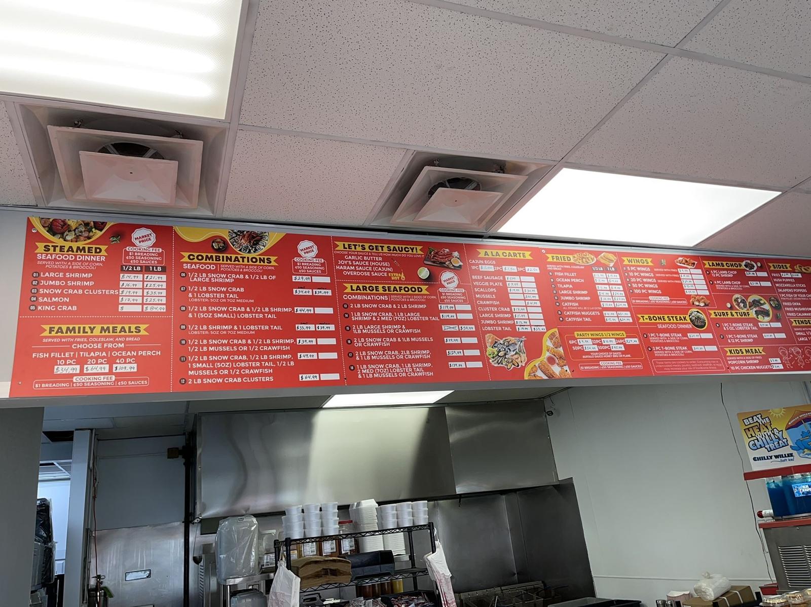 Custom large-format restaurant menu board installed above the kitchen counter