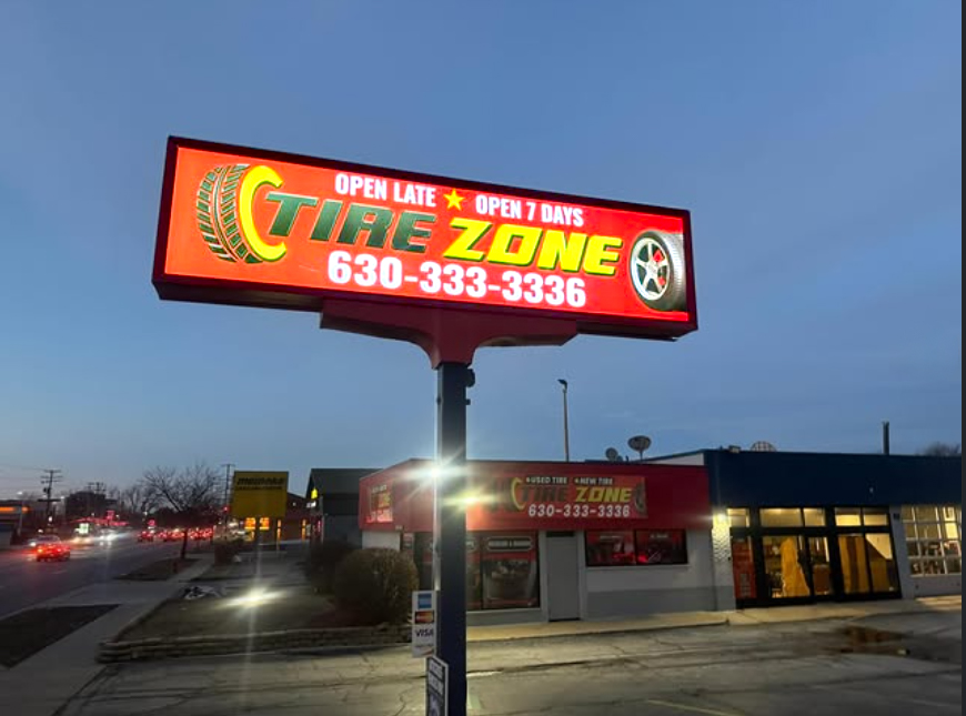 Tire Zone illuminated roadside pylon sign