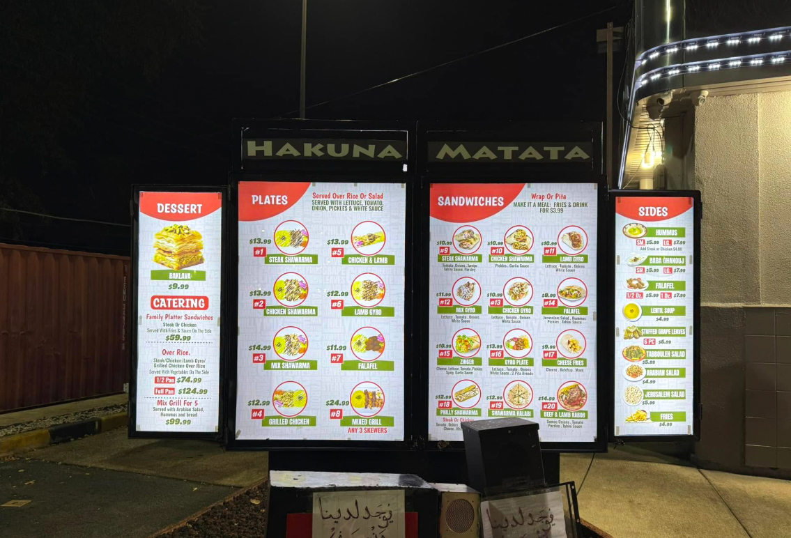 Hakuna Matata illuminated outdoor menu display with custom printed menu panels