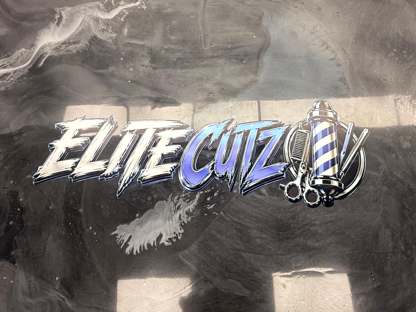 Elite Cutz barbershop interior with custom dimensional wall branding.