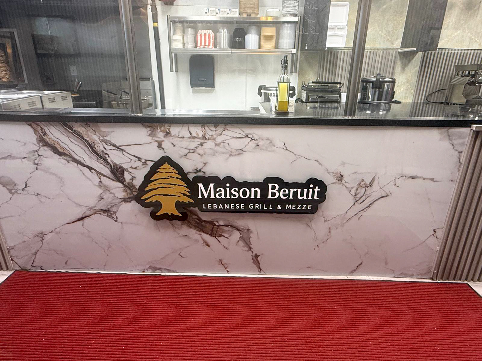 Maison Beruit custom branded interior dimensional sign mounted on a marble counter front
