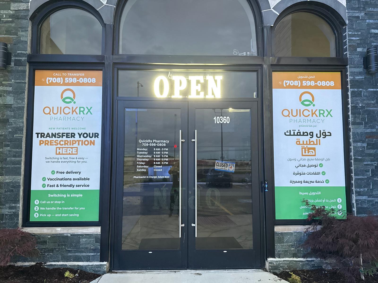 QuickRx Pharmacy entrance with bilingual printed promotional window graphics