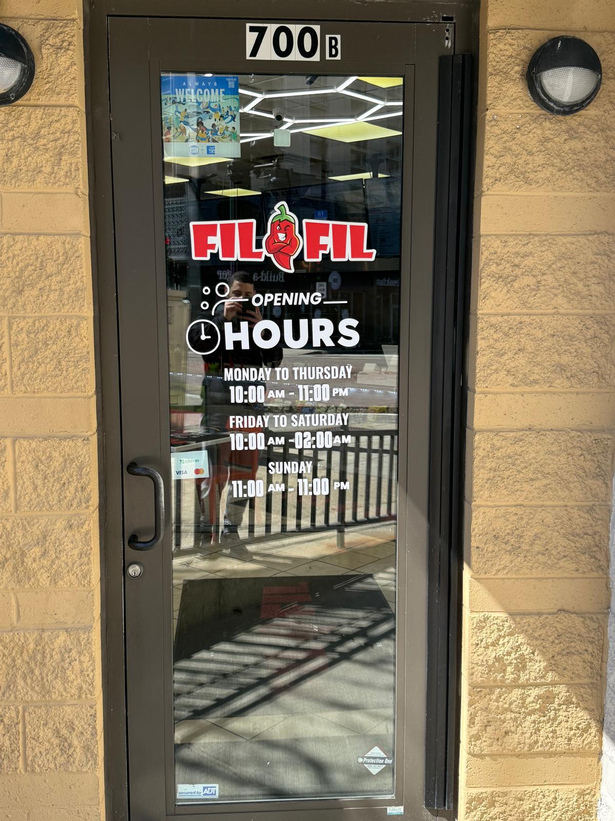 FilFil entrance door with custom logo and business hours vinyl graphics