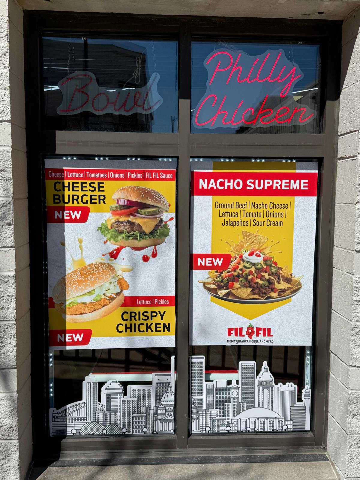 FilFil restaurant windows with custom burger and nacho promotional graphics
