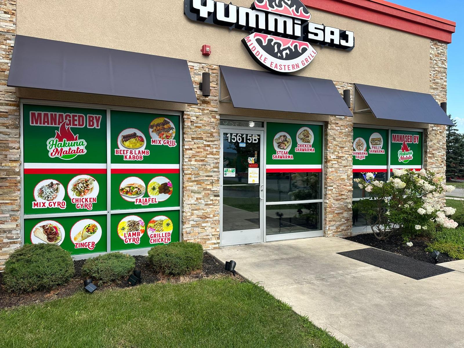 Qummi Saj storefront with custom green restaurant window graphics