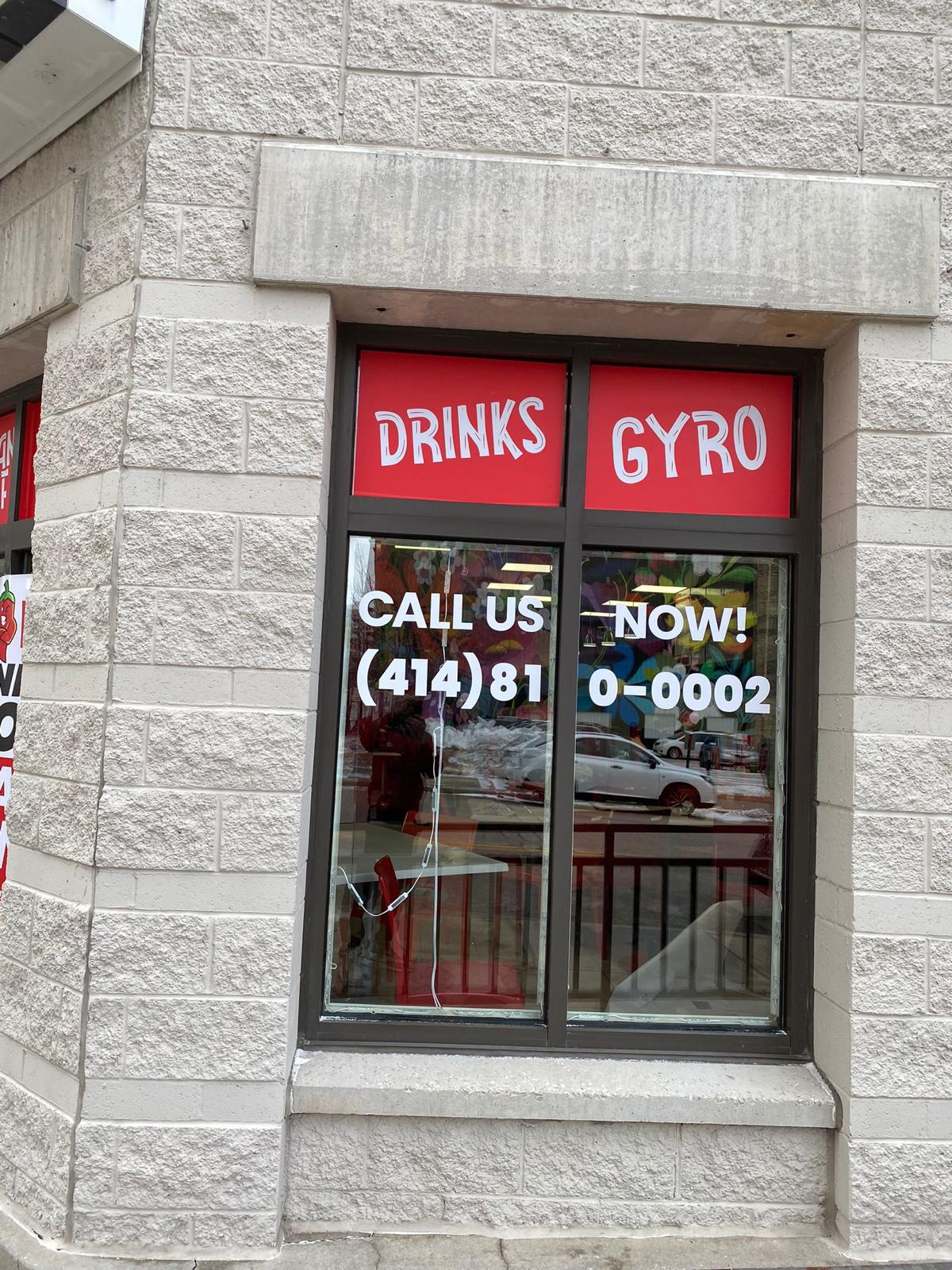 FilFil storefront window with drinks gyro and contact vinyl graphics